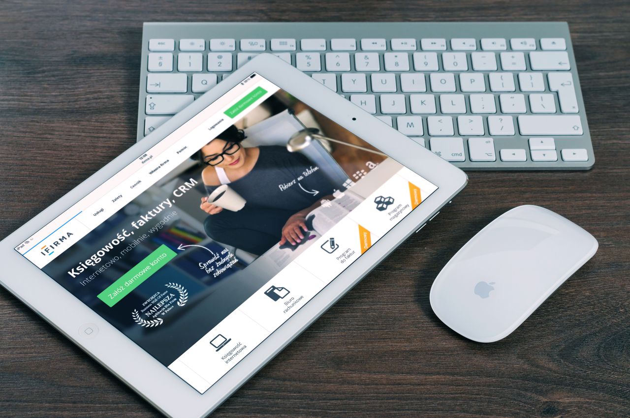 contact-img A tablet with a financial website open, alongside a white keyboard and mouse. Ideal for tech-theme stock images.