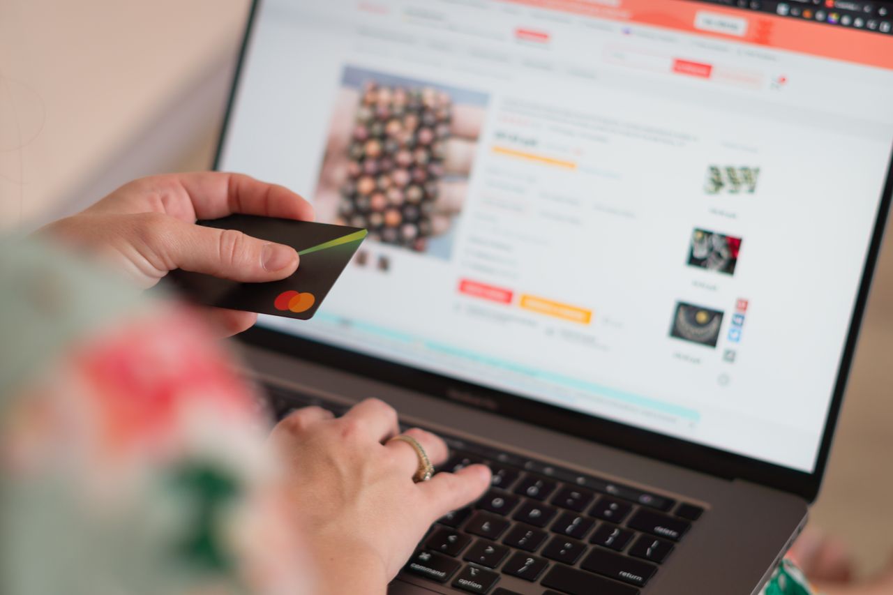 Mastering the First Impression: Your intriguing post title goes here Engaging in online shopping using a credit card with a laptop for convenience and ease.