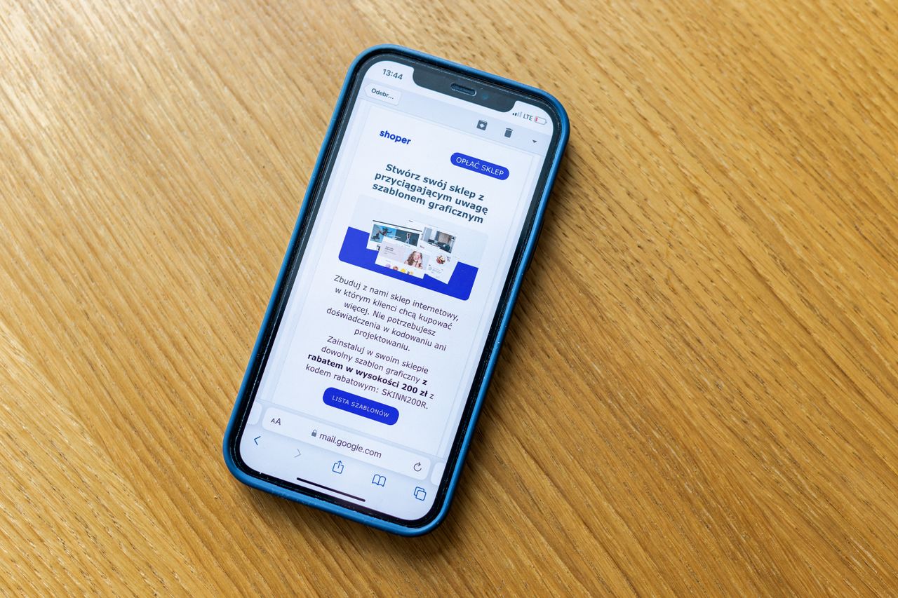 Crafting Captivating Headlines: Your awesome post title goes here Close-up of a smartphone on a wooden table showing an online shopping webpage.