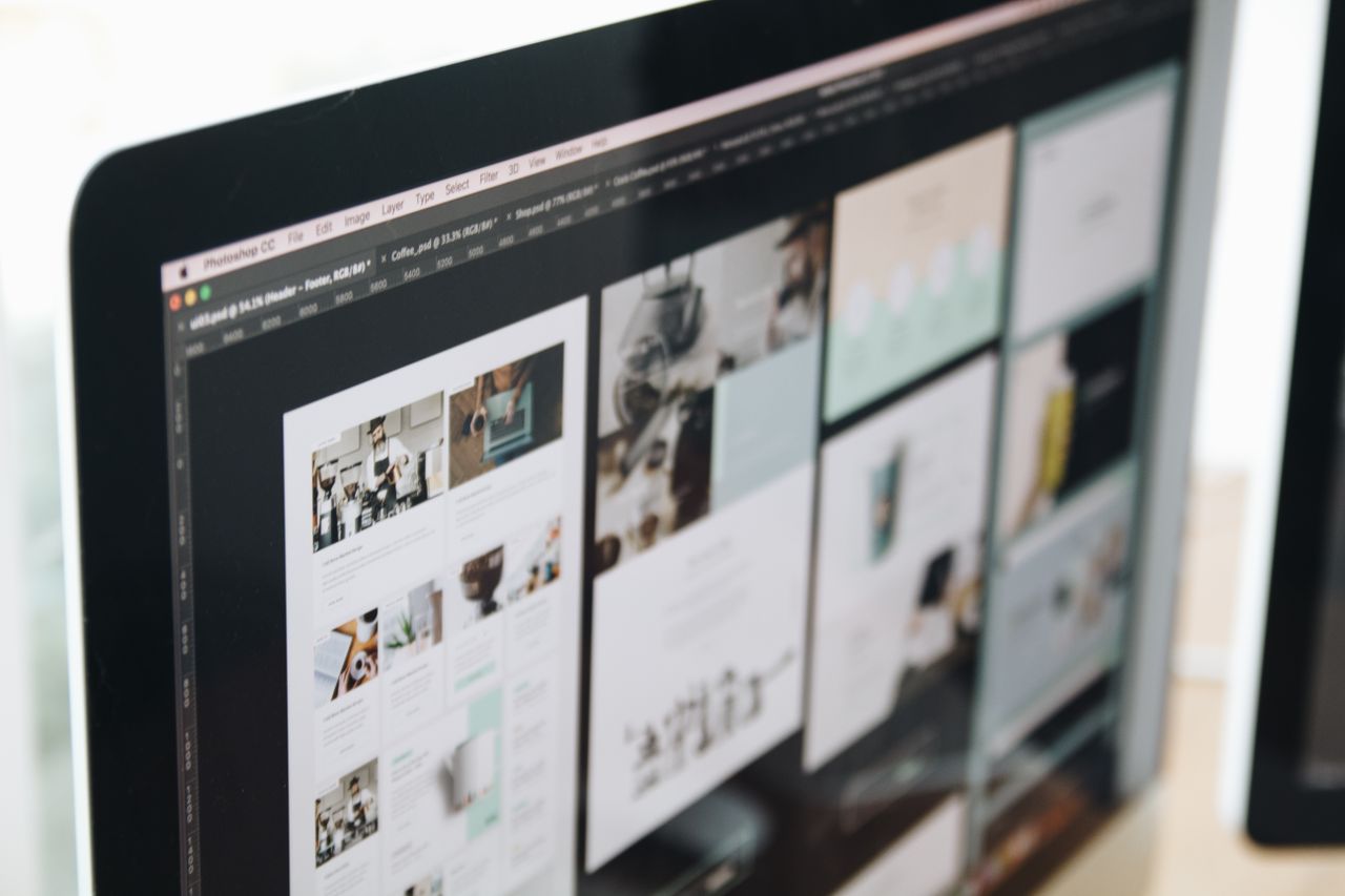 our-experience A modern computer screen displaying web design work, showcasing creative visuals in a workspace.